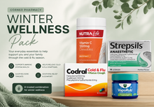 Load image into Gallery viewer, Winter wellness pack with various health products on a wooden surface.
