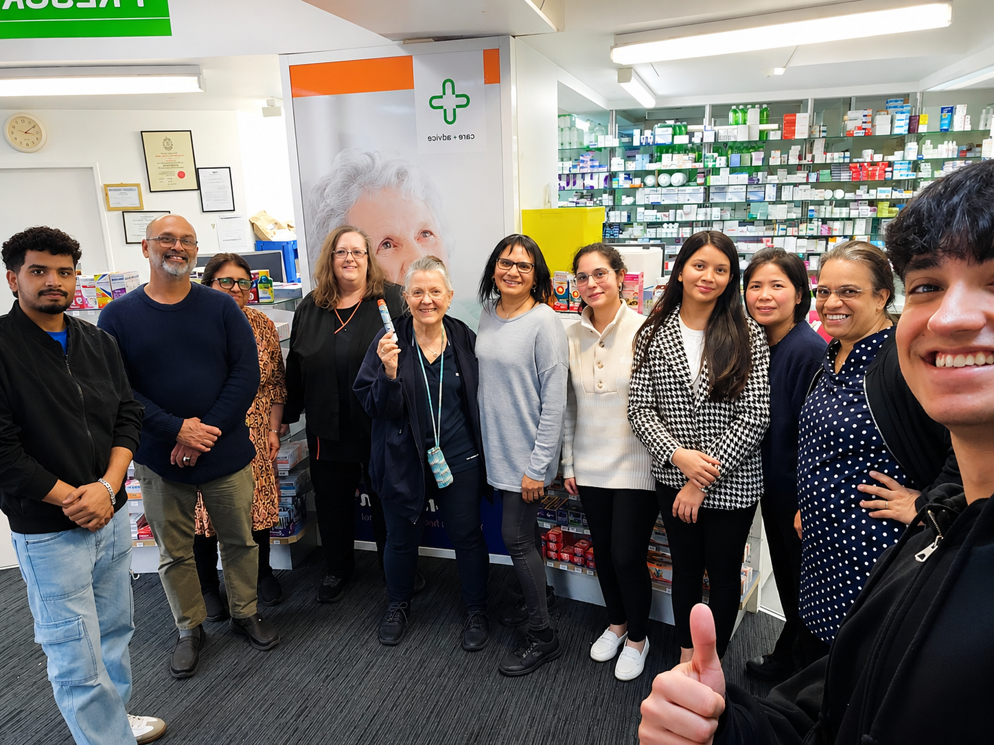 Group of pharmacists posing for a photo in a pharmacy setting